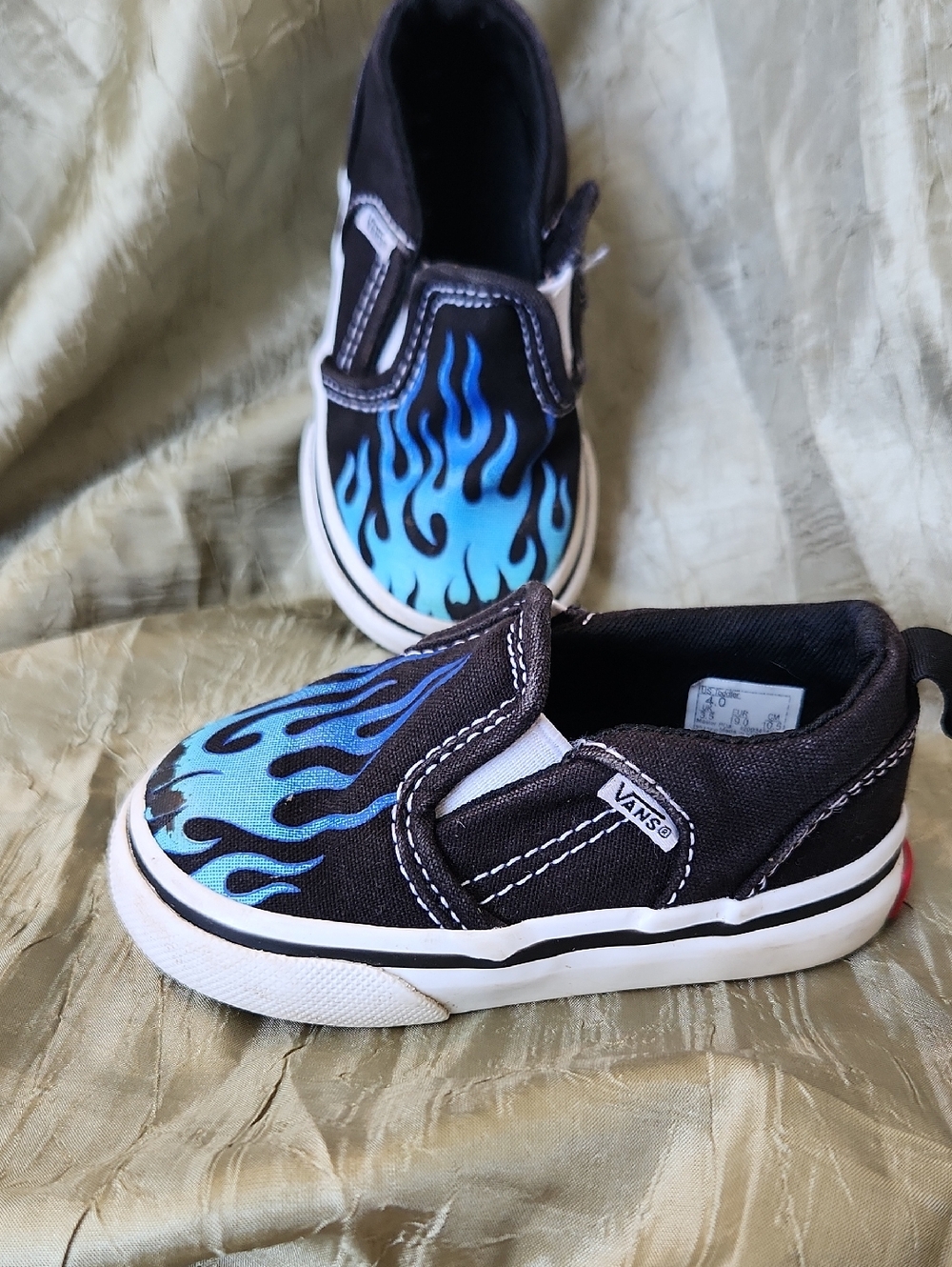 Vans Kids Slip-On Sneakers with Blue Flame Graphic on Black Canvas